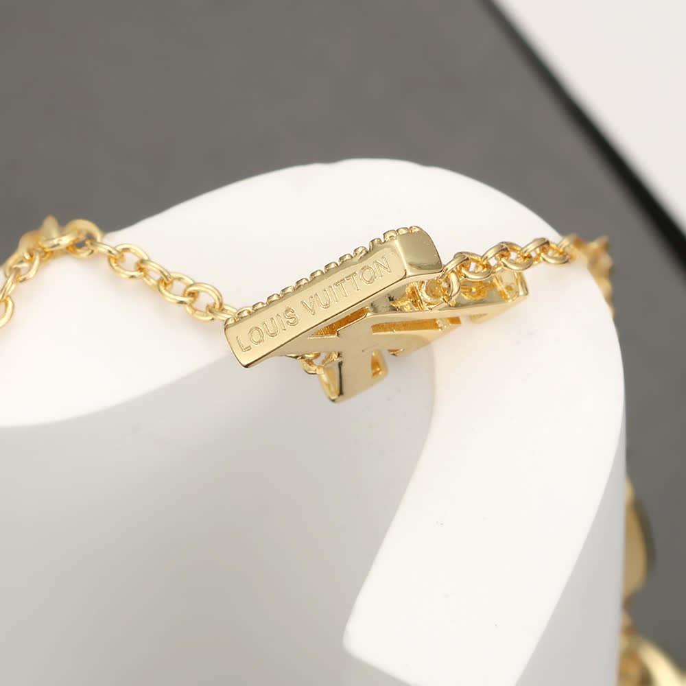 Louis Vuitton Gold Tone Bracelet with Monogram Charm